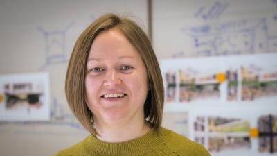 Headshot of Heather Leeson. A woman smiling, wearing a green top.