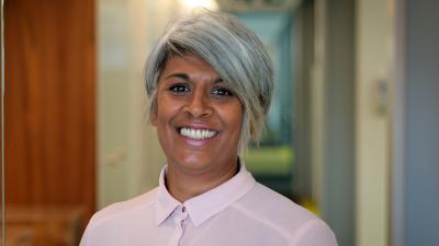 Headshot of Chithra Marsh. A woman smiling, wearing a pink blouse.