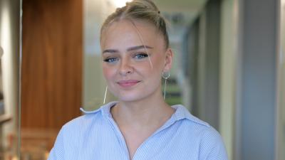 Headshot of Freya Needham. A blonde woman wearing a blue shirt smiling at the camera.