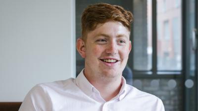 Headshot of Kyle Entwistle, a man wearing a white shirt.