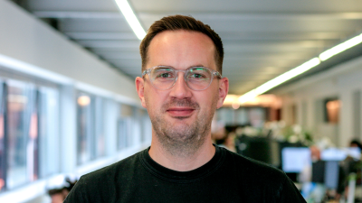 Headshot of Edward Kepczyk - a man with glasses and a black t-shirt.