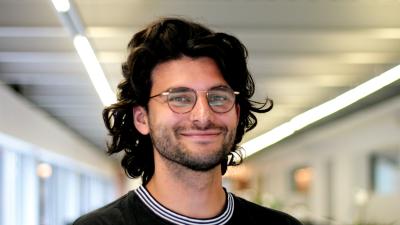 Headshot of Ed Kamal - a man with dark hair and glasses smiling at the camera.