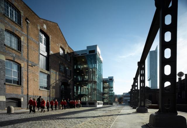 exterior of MSI great western warehouse, with pupils walking along