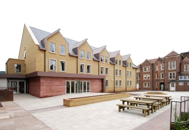 Exterior image of a contemporary sixth form boarding house, which opens onto a central courtyard.