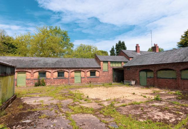 Colour picture of vacant riding stables.  