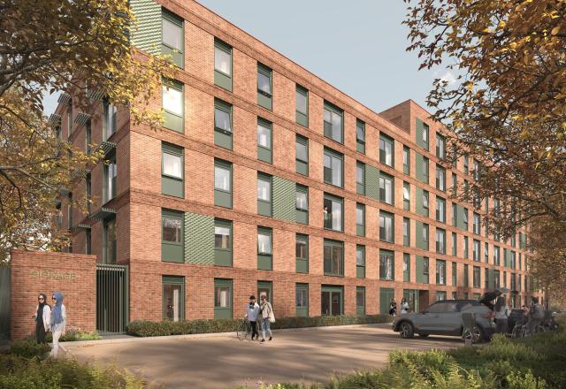 Pink/brown block of apartments on a tree lined area