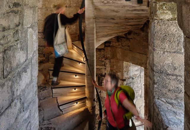 two ladies walk up the spiral staircase at caernarfon castle