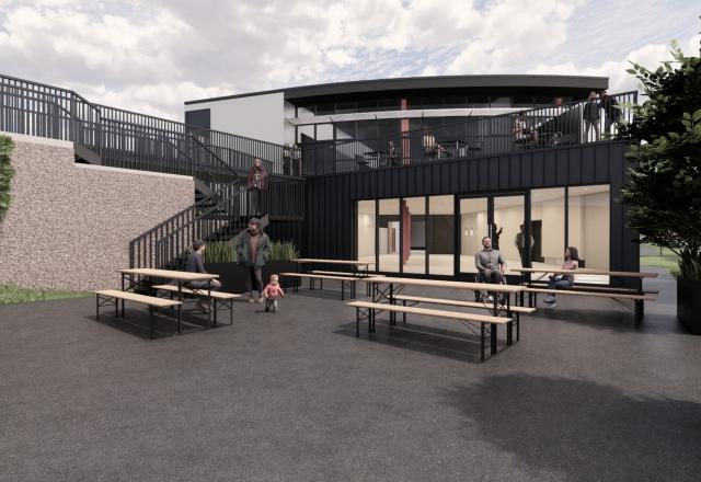 A CGI of Anderton Boat Lift, a courtyard with picnic benches in front of a building with glass and black panelling.