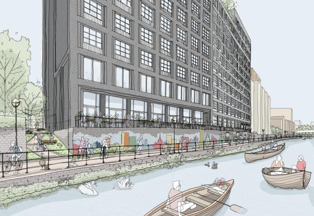 A grey building with windows beside a river. The river contains people on rowing boats.