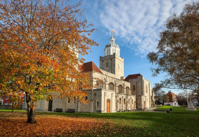 Portsmouth Cathedral - a white brick church building with an orange-leaved tree in front of it