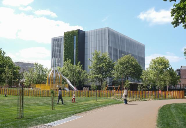 Ancoats Mobility Hub, a steel and green wall strucutre, behind a park.