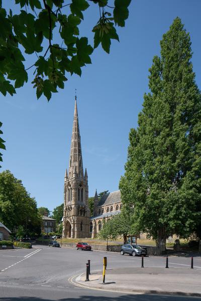 a church with a tall spire on a sunny day