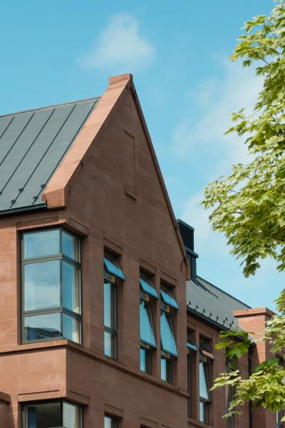 Exterior image of a red sandstone academic building.