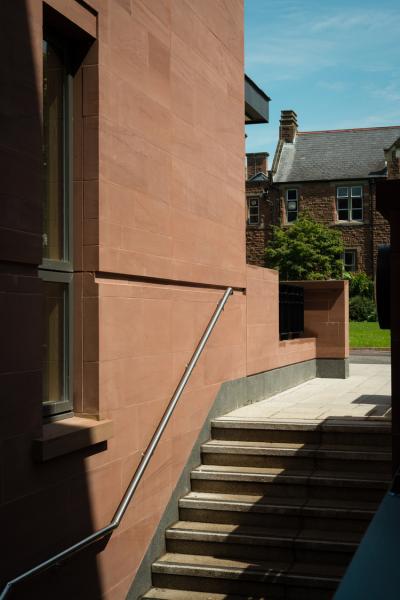 Exterior image of a red sandstone academic building.