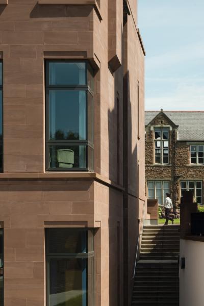 Exterior image of a red sandstone academic building.