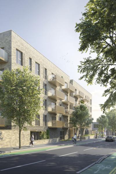 A view of the apartments from the opposite direction on a tree lined street 