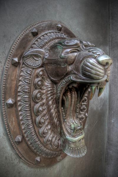 a decorative door know in the shape of a roaring lion