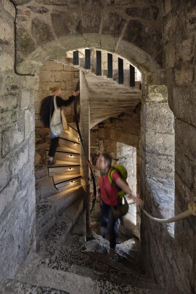 people walk up the spiral stair at Caernarfon Castle