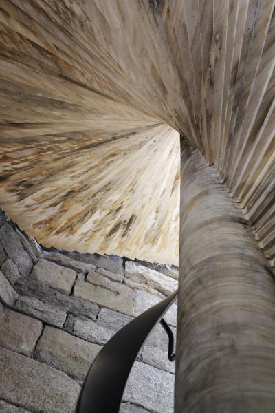 the underside of a timber spiral staircase 