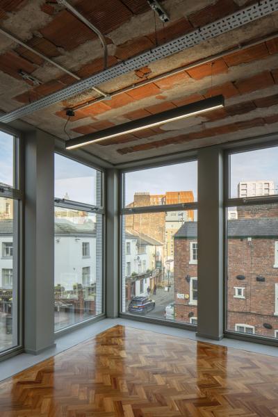 floor to ceiling windows frame the corner of the office space at Hilton House