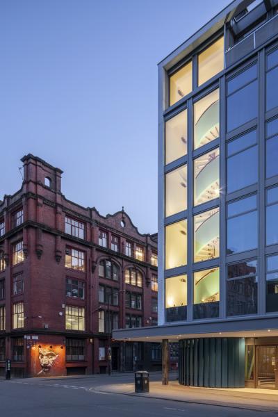 a dusk shot of hilton house with the stairwell lit up