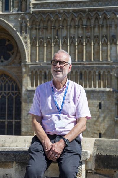 a man sits in front of lincoln cathedral