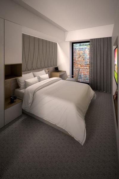 a hotel bedroom with neutral grey decoration