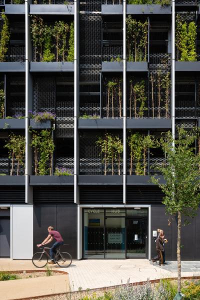 Modern building with vertical greenery and a 'Cycle Hub' entrance,