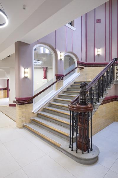 An internal main staircase restored within a historic building.