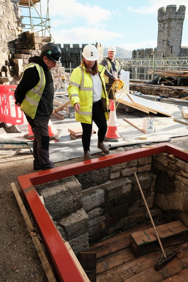 two buttress staff in hi-vis assessing castle work