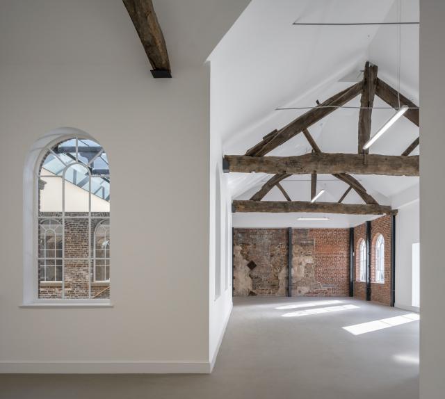 interior of first white cloth hall, exposed beams and white walls