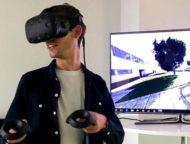 man using VR equipment facing away from screen