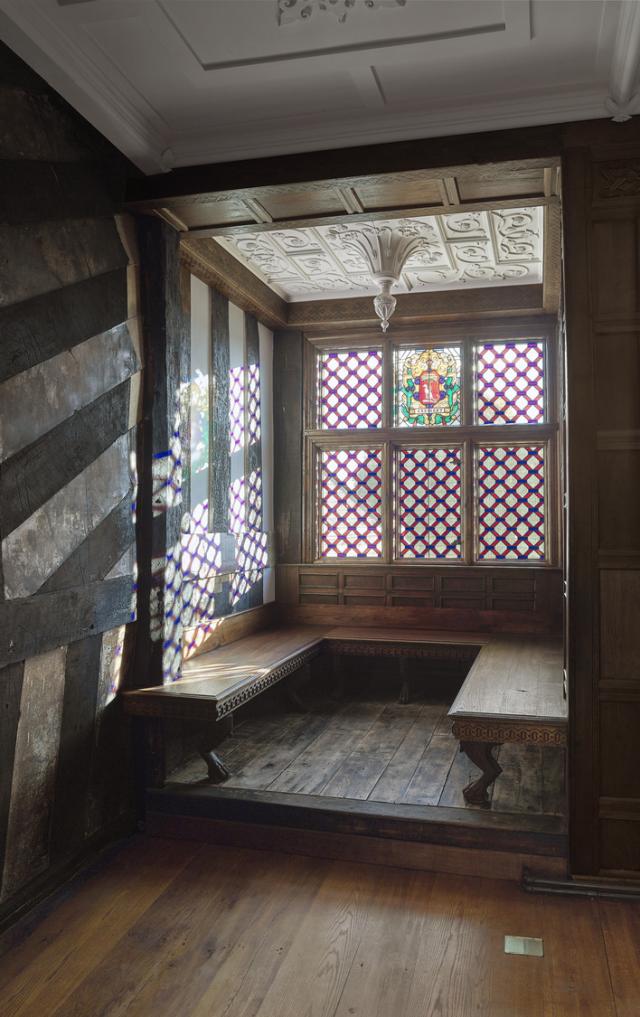 Interior of a 16th century manor house. The building, which was destroyed by fire, has been restored. Light is filtering through the window.