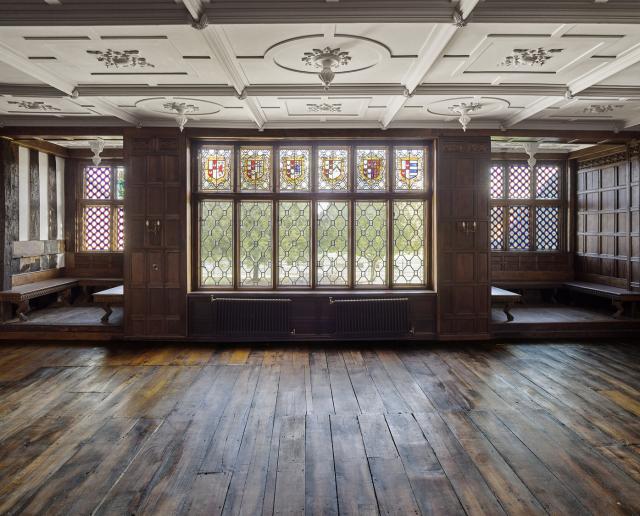 Interior of a 16th century manor house. The building, which was destroyed by fire, has been restored. Light is filtering through the window.