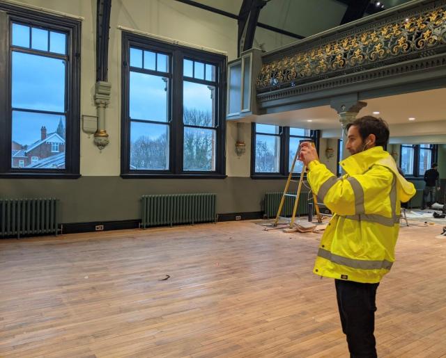 adam lewis in hi-vis on site at stretford public hall 