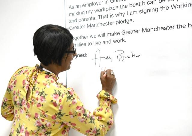 chithra signing wall board with text on it