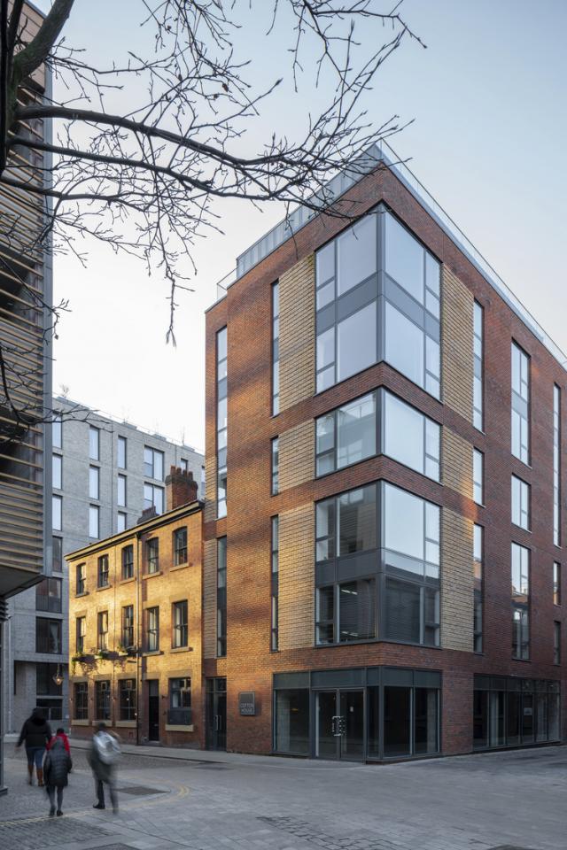 exterior of cotton square, tall building with tones of terracotta