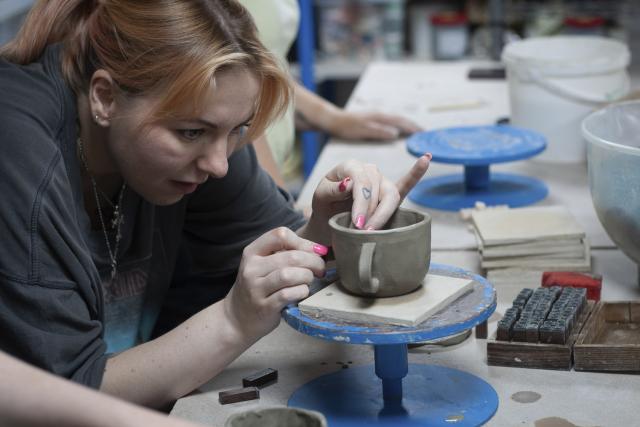 grace avery participating in pottery