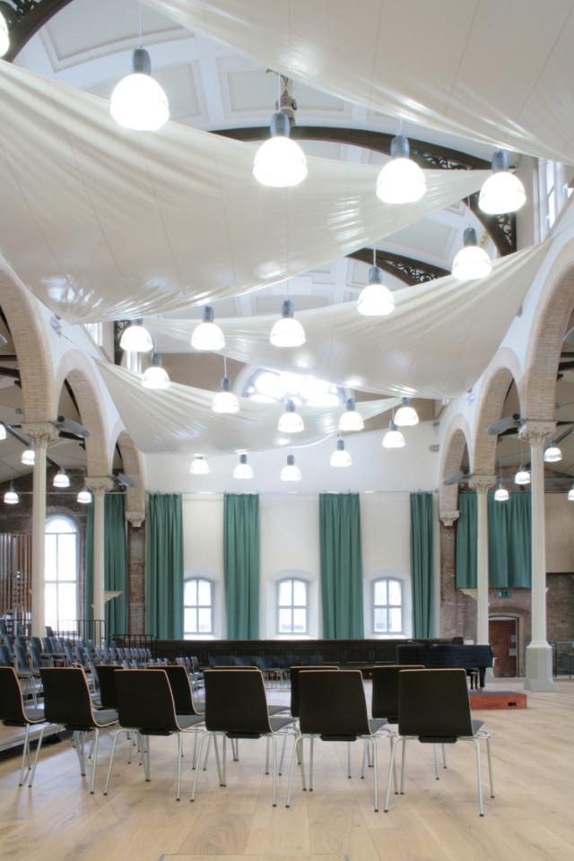 interior of halle st peters, fabric draped across ceiling, bright lights and chairs