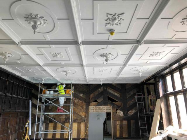 worker in hi-vis working on historic ceiling at wythenshawe hall