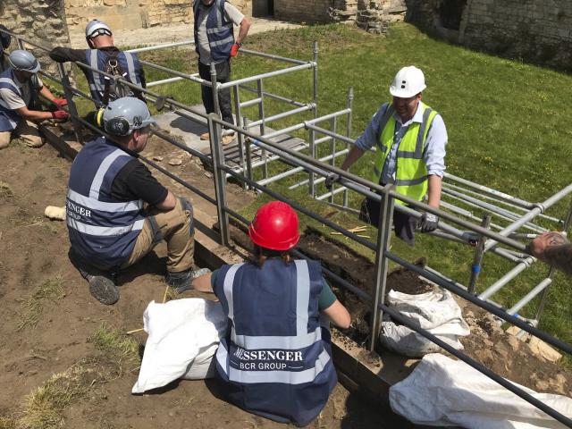 scaffolding on ground on site with construction workers in vests