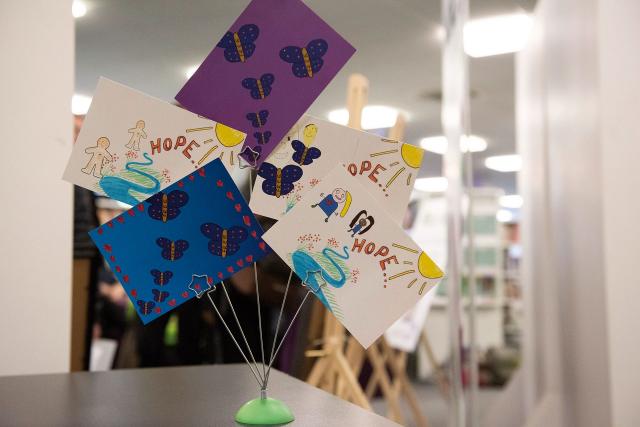 decorated drawings on cards in holder on desk