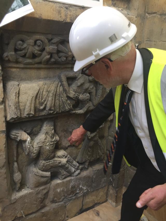 Architect examining medieval stone carving