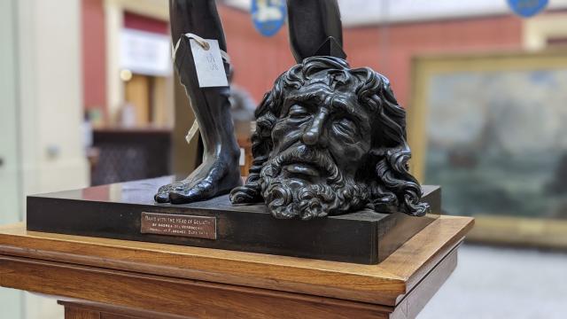 Close-up image of a 15th century statue depicting David with the head of Goliath.