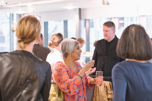 a group of people chat at an event