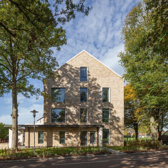 the gable end of a stone boarding house for wycliffe college by Buttress