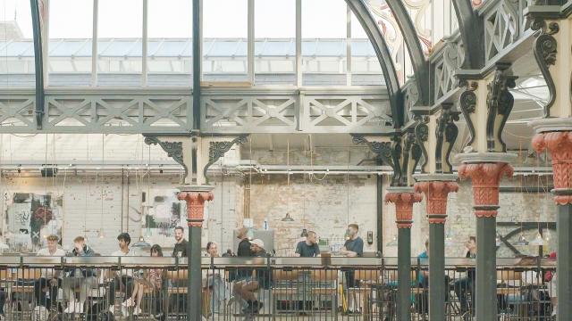 the upper floor of a food hall with cast iron structure and glazed roof