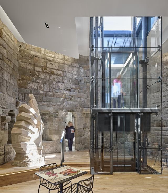 The lift at Caernarfon Castle, next to the Hand statue indoors.