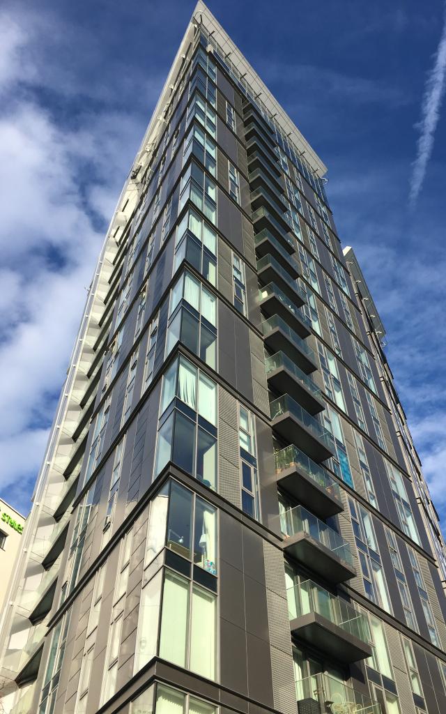 The Arc Building, a high rise glass skyscraper with balconies