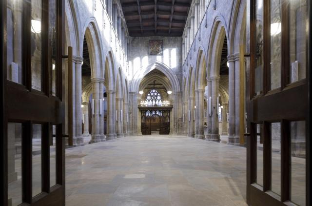 looking to the interior of a historic church through a set of doors